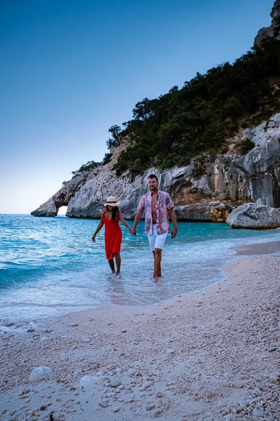 Sardinia Orosei coast Italy, men and woman, young couple adult on vacation at the Island of Sardinia on a boat trip to all the white pebble beaches some of the most beautiful beaches in Europe — Stockfoto