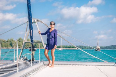 Seychelles, young men on vacation with sailing boat at the Seychelles tropical island