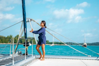 Seychelles, young men on vacation with sailing boat at the Seychelles tropical island
