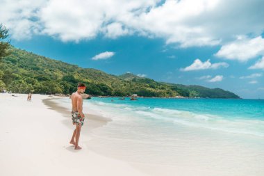 Seychelles tropical Island, Young man on the white beach during Holiday vacation Mahe Seychelles, Praslin Seychelles