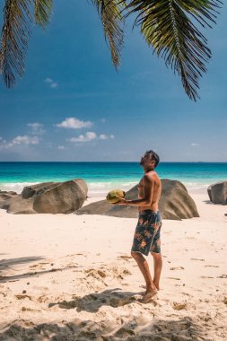 Seychelles tropical Island, Young man on the white beach during Holiday vacation Mahe Seychelles, Praslin Seychelles