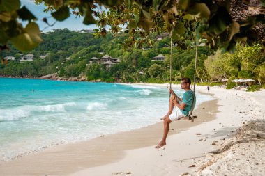 Seychelles tropical Island, Young man on the white beach during Holiday vacation Mahe Seychelles, Praslin Seychelles