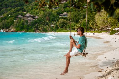 Seychelles tropical Island, Young man on the white beach during Holiday vacation Mahe Seychelles, Praslin Seychelles