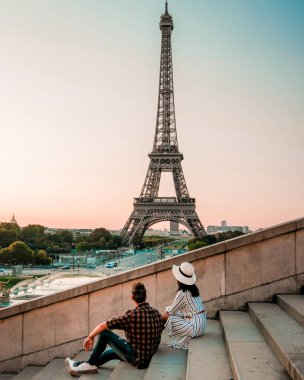 Morning wake up in bed in Paris with breakfast coffee and a newspaper, couple in bed men and woman honymoone valentine couple