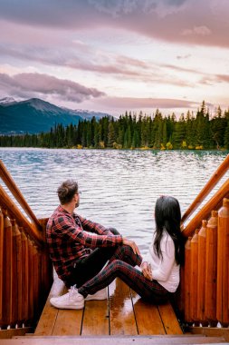 Jasper kasabası Kanada, göl kıyısında bir çift, Jasper Gölü 'nde gün doğumu, Beauvert Gölü Alberta Kanada Kayalıkları