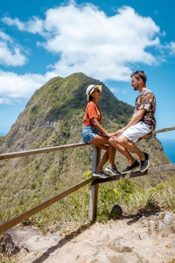 couple hiking in the mountains Saint Lucia Caribbean, nature trail in the jungle of Saint Lucia with a look at the huge Pitons