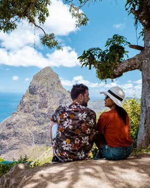 couple hiking in the mountains Saint Lucia Caribbean, nature trail in the jungle of Saint Lucia with a look at the huge Pitons