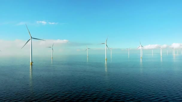 Windmolenrij windmolens in de oceaan aan het IJsselmeer Nederland, duurzame energie windmolenpark Flevoland — Stockvideo