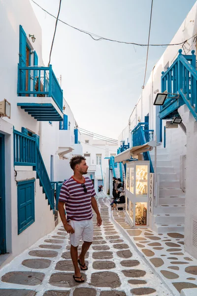 Young men on vacation Greece, Mykonos Greece, Little Venice Mykonos Greece, sunset at ocean fron at Mykonos town — Stock Photo, Image