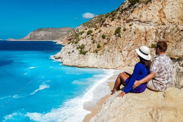 Koppel op vakantie Turkije, Kaputas Beach Kas kalkoen, wit oranje strand van kliffen door de oceaan van Kas Turkije rivera, mannen en vrouwen die op klif uitziende oceaan — Stockfoto