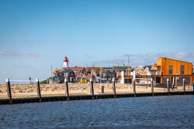 Urk Hollanda 28 Mart 2020, Urk Limanı. Arka planda deniz feneri olan yeni inşa edilmiş bir restoran.