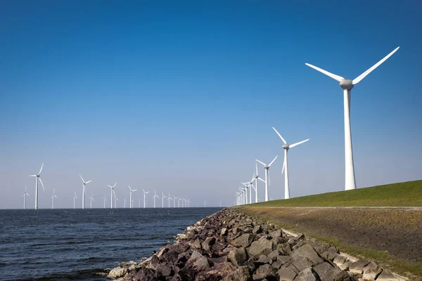 Offshore Windmill farm in the ocean Westermeerwind park , windmills isolated at sea on a beautiful bright day Netherlands Flevoland Noordoostpolder