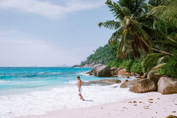 Jonge mannen in zwemmen korte tropische strand Seychellen Mahe, Petite Anse tropische strand Seychellen — Stockfoto