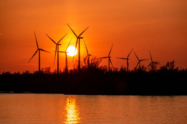 Moerdijk Netherlands, sunset winth windmills by the lake Vokerak river in Holland windmill energy sunset