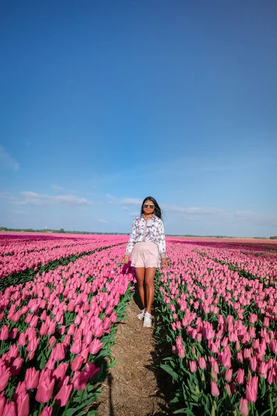 Žena na poli květin, mladá dívka na poli tulipánů v Nizozemsku během jarní sezóny — Stock fotografie