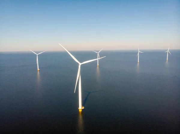 ノードストッポルダーのオランダでカラフルなチューリップ畑を持つ風車農場、海と土地で緑のエネルギー風車 — ストック写真