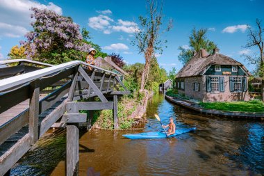 GIETHOORN, NETHERLANDS Mayıs 2020 tipik Giethoorn evleri Mayıs 2020 'de Hollanda, Giethoorn' da görülmektedir. Güzel evler ve bahçıvanlık şehri kuzeyin Venedik 'i olarak bilinir.