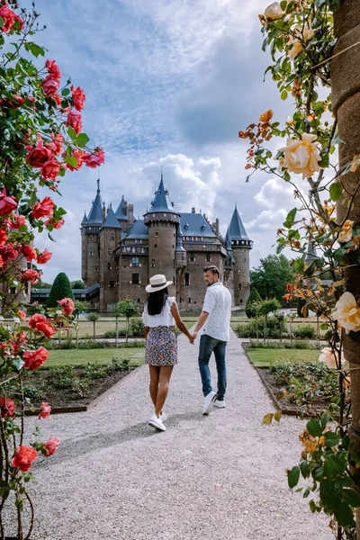 Old historical castle garden,Castle de Haar Netherlands Utrecht on a bright summer day, young couple men and woman mid age walking in the castle garden — Stock Photo, Image