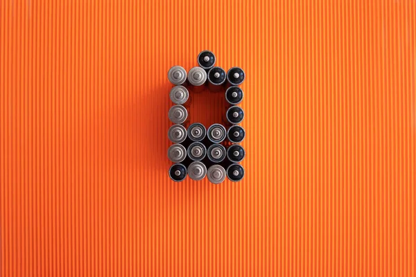 Phone battery symbol consisting of aa batteries on an orange backround