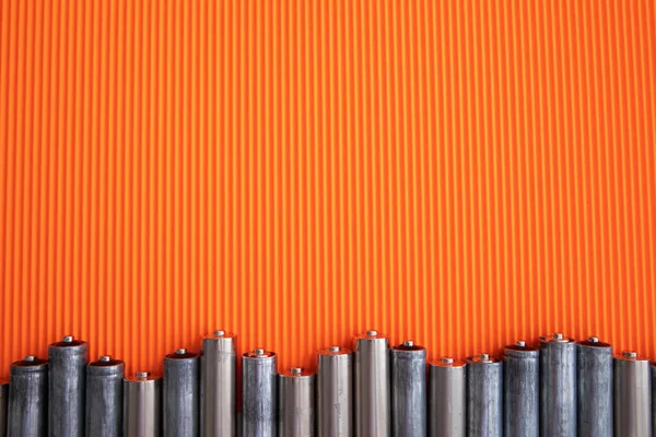 Silver Batteries Orange Background Stock Image