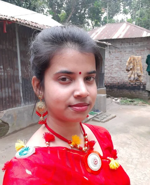 Indian village girls in red dress.