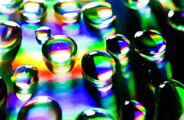 Colorful water ball, it's a water drop on a CD player and the light is being reflected.