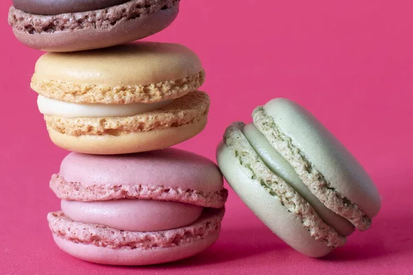 Closeup shot of stack of macaroons on pink background