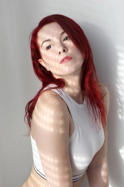 The young sexy redhead woman in white portrain