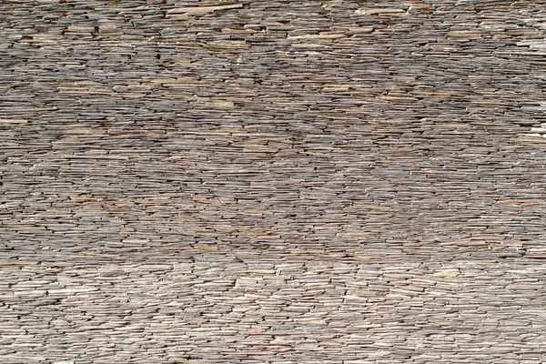 Taş kiremit duvar dokusu. Duvarın bir parçası. Yığılmış taş duvar arkaplanı.