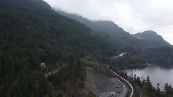 Luftaufnahme Der Mit Kiefernwald Bedeckten Berge Autobahn Flussnähe Und Güterzug — Stockvideo