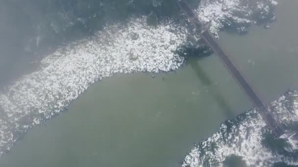 横断橋と光の雪で覆われた海岸と川の空中風景 — ストック動画
