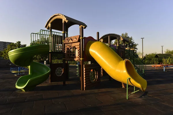 playground, park, play, slide, children, fun, child, outdoor, summer, colorful, oil, blue, kids, childhood, equipment, sky, game, green, swing, industry, yellow, school, activity, playing, leisure