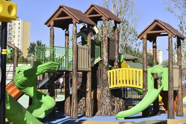 playground, slide, park, play, beach, children, fun, childhood, summer, outdoor, sand, colorful, outdoors, child, blue, sky, toy, building, wood, green, recreation, equipment, outside, wooden, school