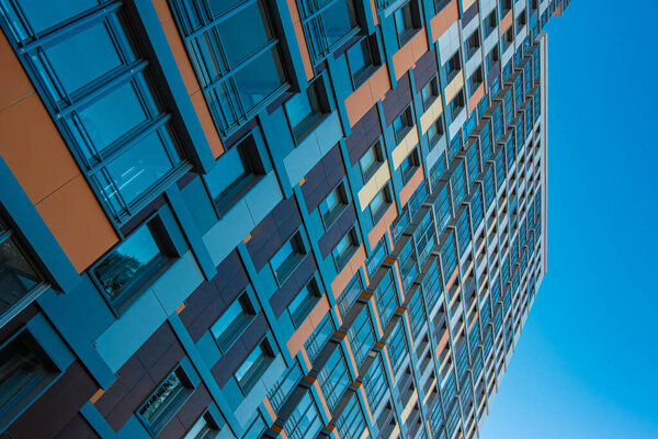 High-rise new building on a background of blue sky