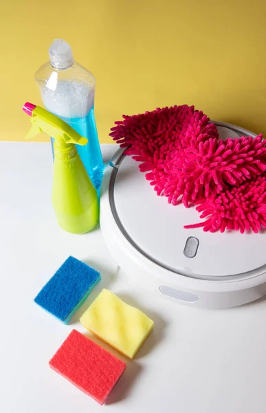 modern home cleaning products. Robot vacuum cleaner, cleaning sponges, cleaning chemicals, pulverizer, long-hair rag