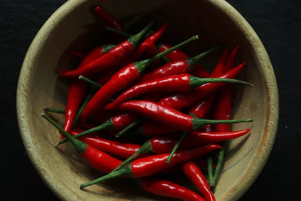 Photography of red hot peppers in a wooden bowl for food background — 스톡 사진