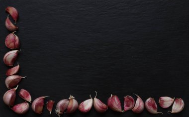 Photography of garlic cloves on slate background for restaurant menu