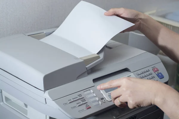 Midsection of businesswoman using fax machine in office — Stock Photo, Image