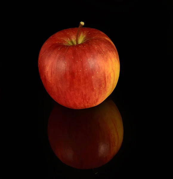 Red apple on a black background