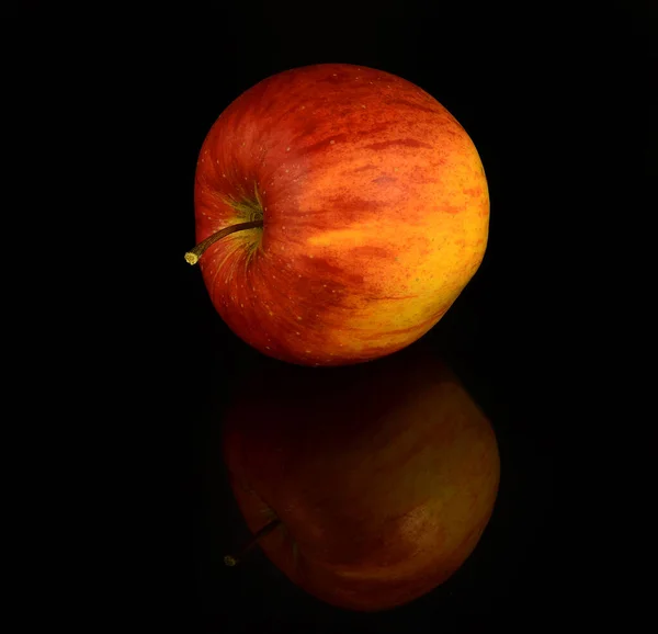 Red apple on a black background