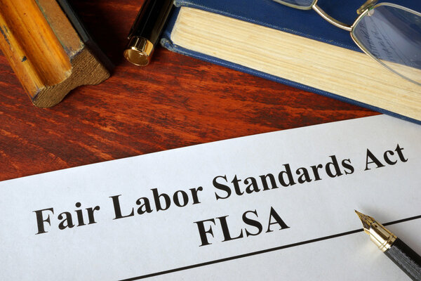 FLSA Fair Labor Standards Act and a book.