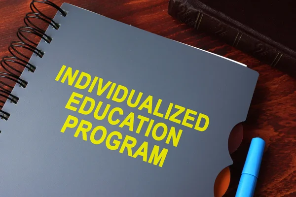 Book with title individualized education program (IEP) on a table. — Stock Photo, Image