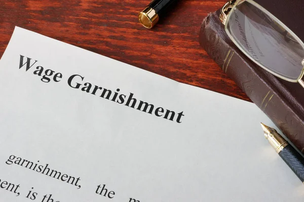 Wage Garnishment definition written on a paper. — Stock Photo, Image