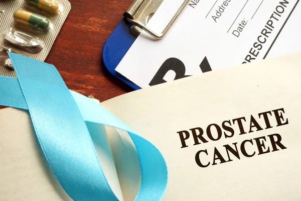 Prostate cancer written on a page and  blue awareness ribbon. — Stock Photo, Image