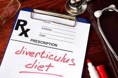 Prescription form with words diverticulitis diet on a table. clipart
