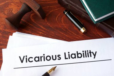 Papers with title Vicarious Liability on a table. clipart