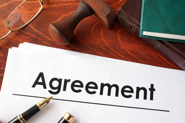 Agreement form on an office table.