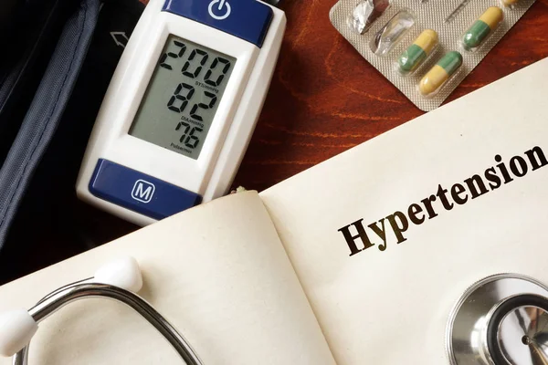 Hypertension title in a book and stethoscope. — Stock Photo, Image