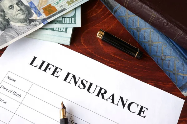 Life insurance policy and currency on a table. — Stock Photo, Image