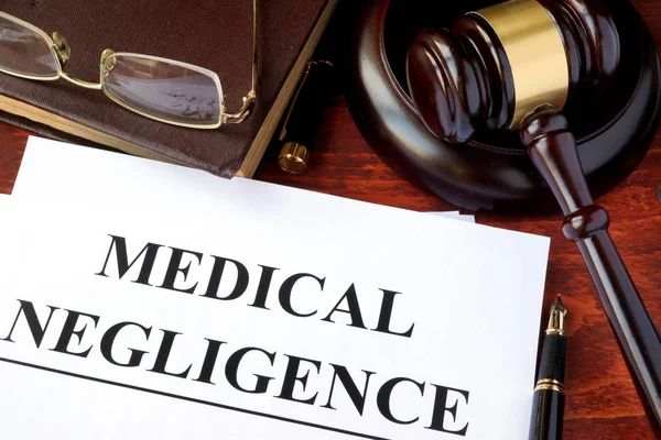 Medical Negligence form, documents and gavel on a table. — Stock Photo, Image